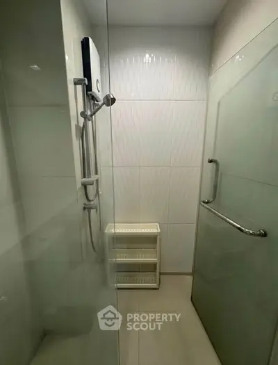 Modern bathroom with glass shower enclosure and sleek fixtures