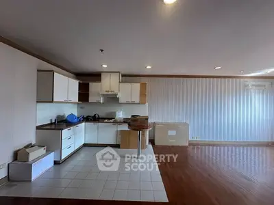 Spacious open-layout kitchen with modern cabinets and ample natural light