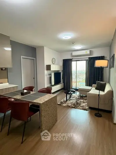 Modern living room with open layout, stylish furniture, and balcony view in a contemporary apartment.