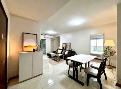 Spacious modern living room with dining area and stylish decor in a bright apartment.