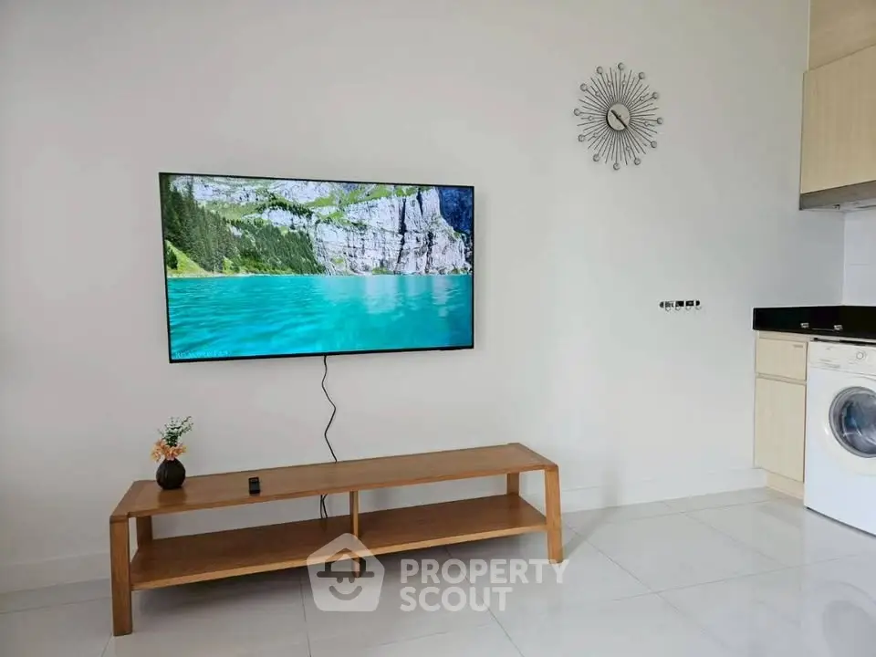 Modern living room with wall-mounted TV and sleek furniture