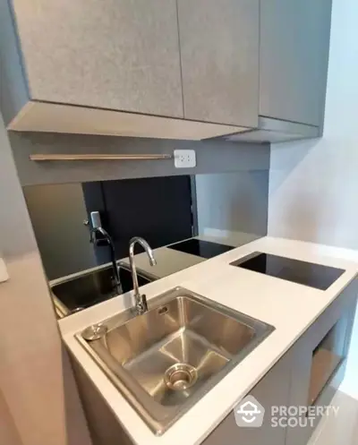 Modern compact kitchen with sleek design and stainless steel sink