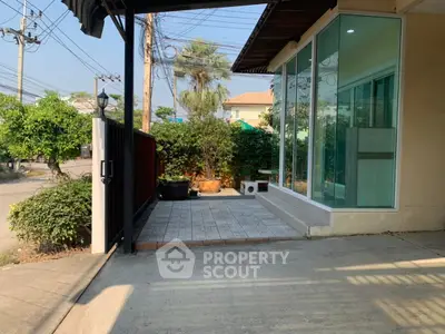 Charming exterior view of a modern home with spacious driveway and lush greenery.