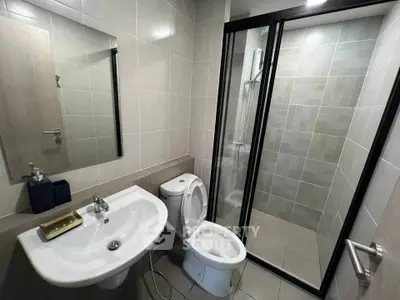 Modern bathroom with sleek fixtures and glass shower enclosure