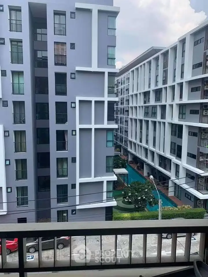 Modern apartment buildings with pool view from balcony, ideal urban living.