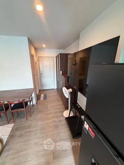 Modern apartment interior with sleek furniture and appliances, featuring a spacious layout and stylish decor.