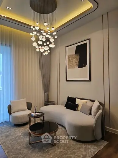 Luxurious living room with modern chandelier and elegant furniture