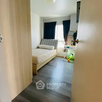 Cozy bedroom with modern decor and natural light, perfect for relaxation and comfort.