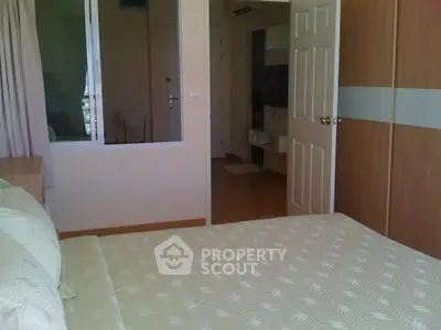 Cozy bedroom with modern decor and ample natural light