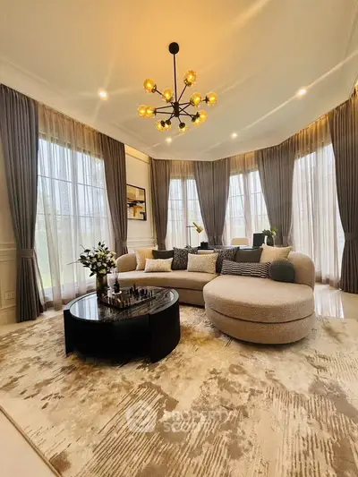 Luxurious living room with elegant chandelier and panoramic windows