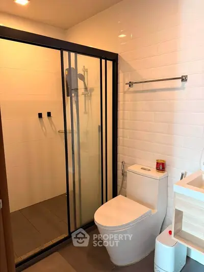 Modern bathroom with sleek shower enclosure and contemporary fixtures.