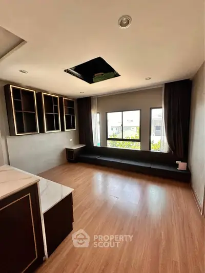 Spacious living room with large window and modern wooden flooring