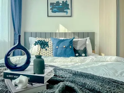 Stylish bedroom with modern decor and cozy bedding, perfect for relaxation.