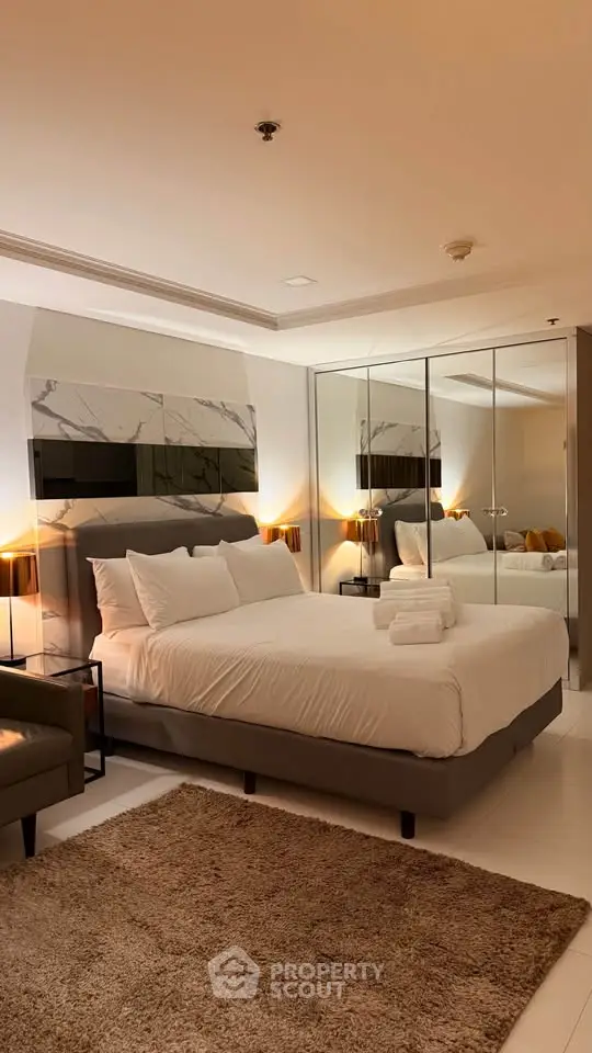 Luxurious bedroom with elegant decor and mirrored wardrobe