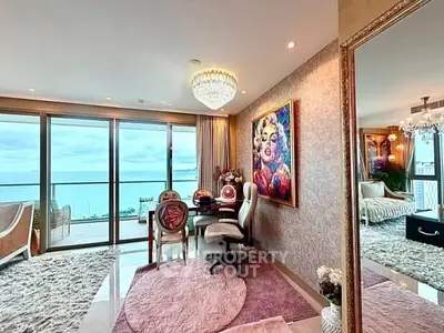 Luxurious living room with ocean view, elegant decor, and spacious balcony access.
