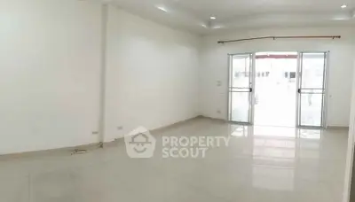 Spacious empty room with large windows and glossy tiled floor, perfect for customization.