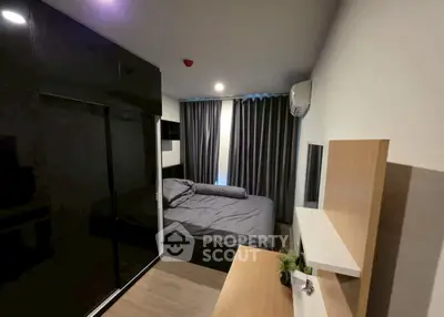 Modern bedroom with sleek black wardrobe and cozy bed setup