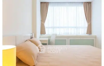 Bright and cozy bedroom with large window and elegant curtains