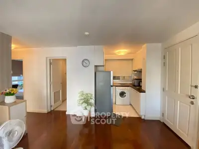 Modern apartment interior with open kitchen and hardwood floors