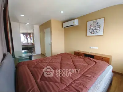 Cozy bedroom with modern decor and air conditioning in a stylish apartment.