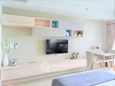 Modern living room with stylish wall-mounted TV and elegant dining area