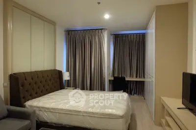 Modern bedroom with elegant curtains and stylish furniture in a cozy apartment.