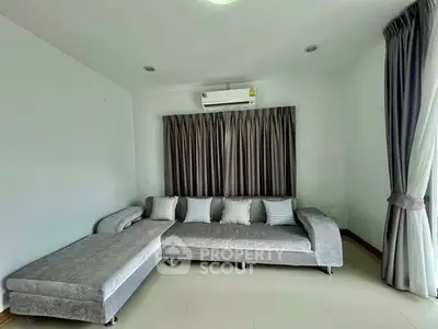 Spacious living room with modern gray sectional sofa and elegant curtains