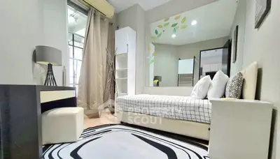 Modern bedroom with stylish decor and large mirror