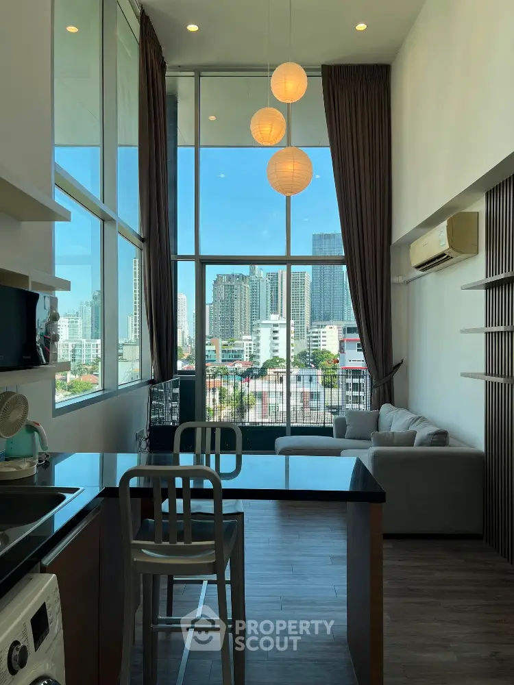 Modern high-rise apartment with floor-to-ceiling windows and city view