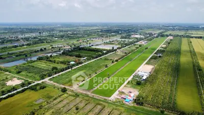 Expansive aerial view of lush green farmland with clear skies, ideal for agricultural investment.