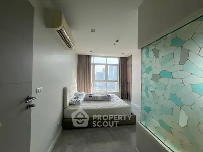 Modern bedroom with large window and city view, featuring stylish decor and natural light.