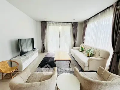Spacious living room with modern furniture and large windows for natural light.