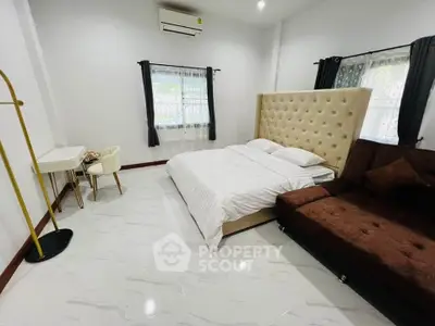 Spacious bedroom with elegant decor and modern furnishings