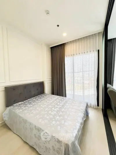 Bright and airy bedroom with large window and elegant decor