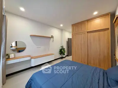 Modern bedroom with wooden wardrobe and stylish decor