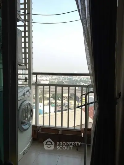 Charming balcony with laundry area and stunning city view, perfect for urban living.