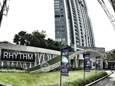 Modern high-rise building with sleek architecture and lush landscaping, ideal for urban living.