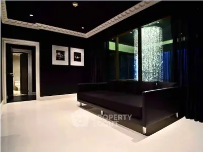 Luxurious modern living room with elegant black decor and stunning chandelier