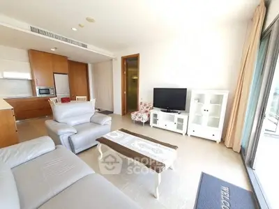 Spacious living room with modern furniture and open kitchen layout