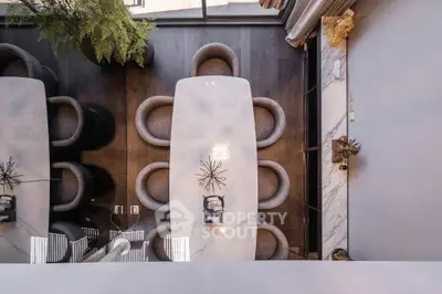 Elegant dining area with modern table and chairs, featuring stylish decor and ambient lighting.