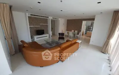 Spacious living room with modern furniture and open layout in a luxury apartment.