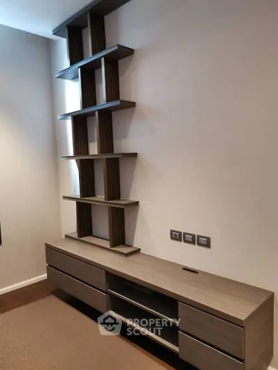Modern living room with stylish shelving and sleek wooden cabinet