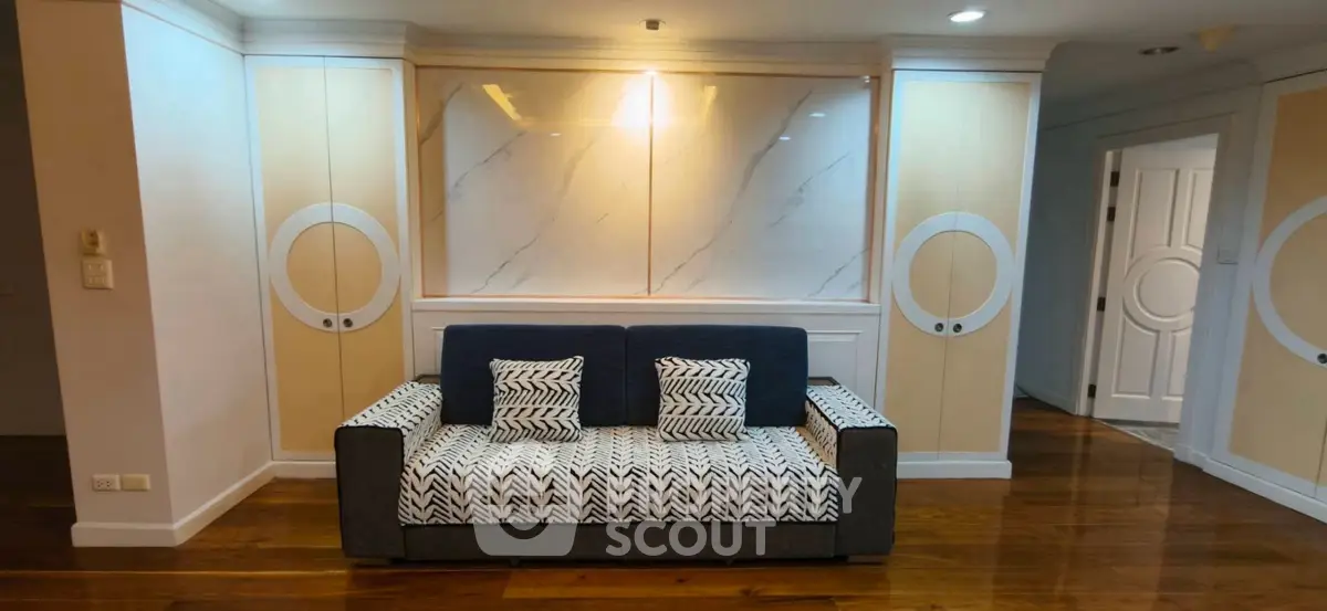 Stylish living room with modern sofa and elegant wall design in a cozy apartment.