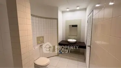 Spacious modern bathroom with elegant tile design and sleek fixtures.