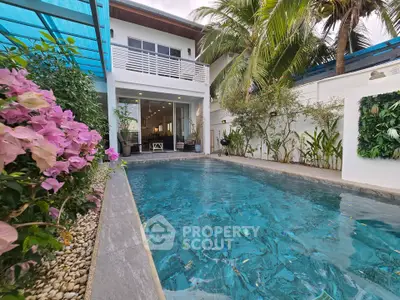 Luxurious villa with private pool and lush garden, perfect for tropical living.