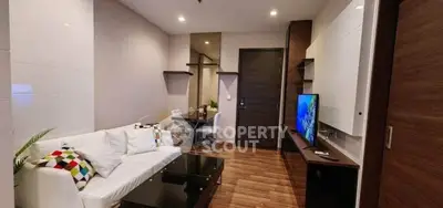 Modern living room with sleek furniture and stylish decor in a cozy apartment setting.