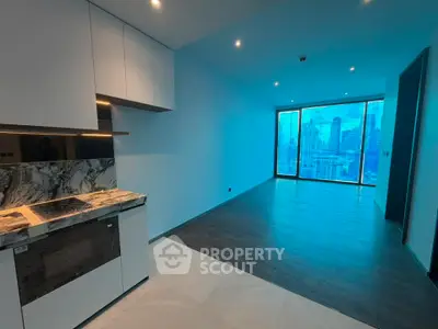 Modern open-plan kitchen and living area with city skyline view