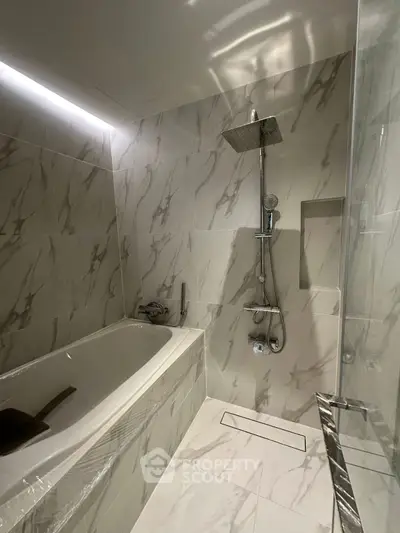 Luxurious marble bathroom with modern shower and bathtub