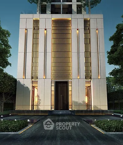 Stunning modern building facade with elegant lighting and lush greenery.