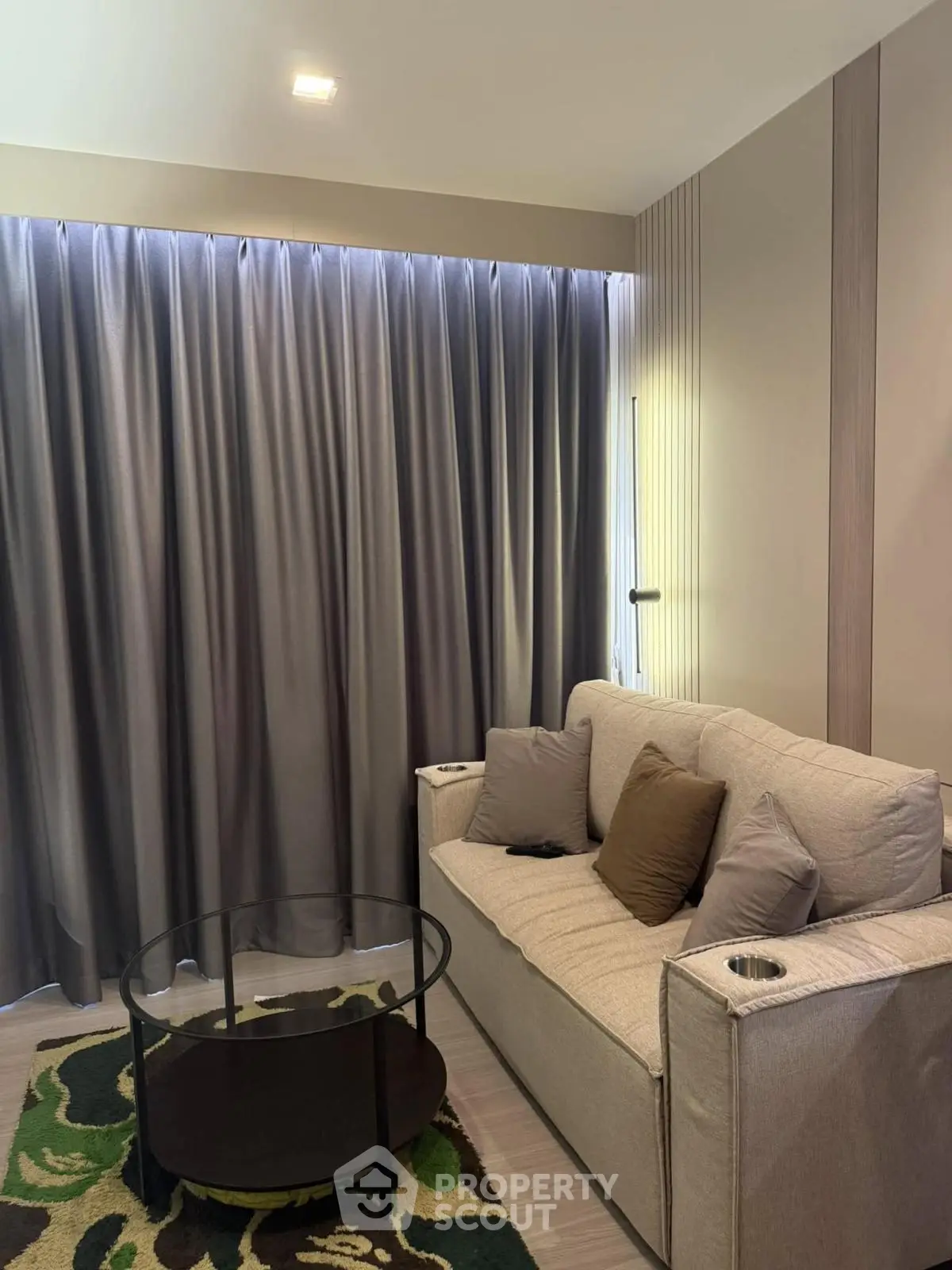 Cozy living room with modern sofa and stylish decor, perfect for relaxation and entertainment.